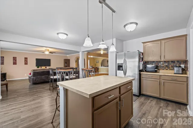 a kitchen with a table chairs refrigerator and cabinets