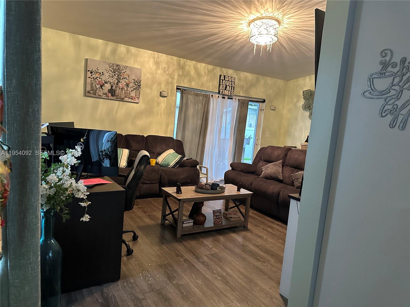 5700 Southwest 54th Terrace Davie, FL 33314 - Photo 16 of 49 a living room with furniture and a flat screen tv