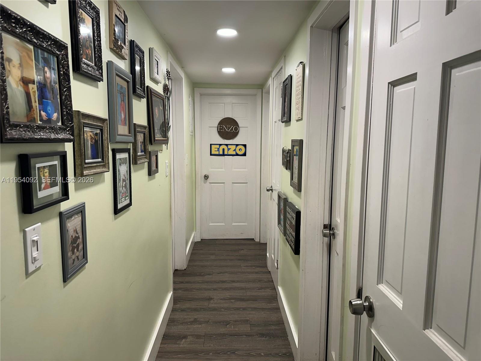 5700 Southwest 54th Terrace Davie, FL 33314 - Photo 18 of 49 a hallway with wooden floor and staircase