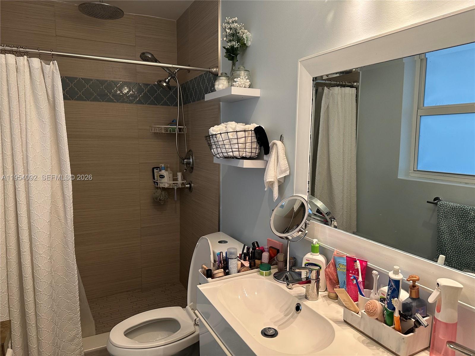 5700 Southwest 54th Terrace Davie, FL 33314 - Photo 23 of 49 a bathroom with a sink vanity mirror and toilet
