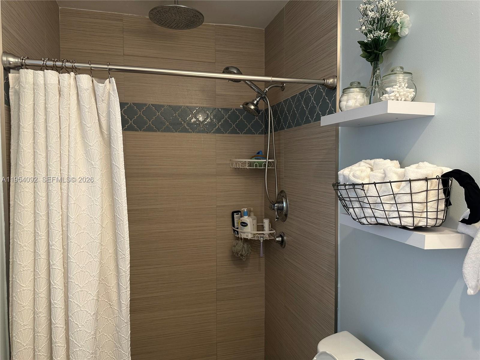 5700 Southwest 54th Terrace Davie, FL 33314 - Photo 24 of 49 a bathroom with a shower curtain and a toilet