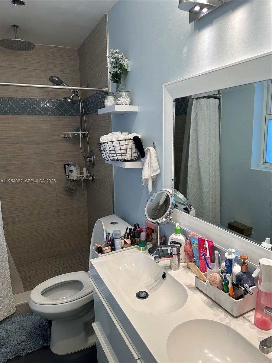 5700 Southwest 54th Terrace Davie, FL 33314 - Photo 25 of 49 a bathroom with a sink mirror and toilet