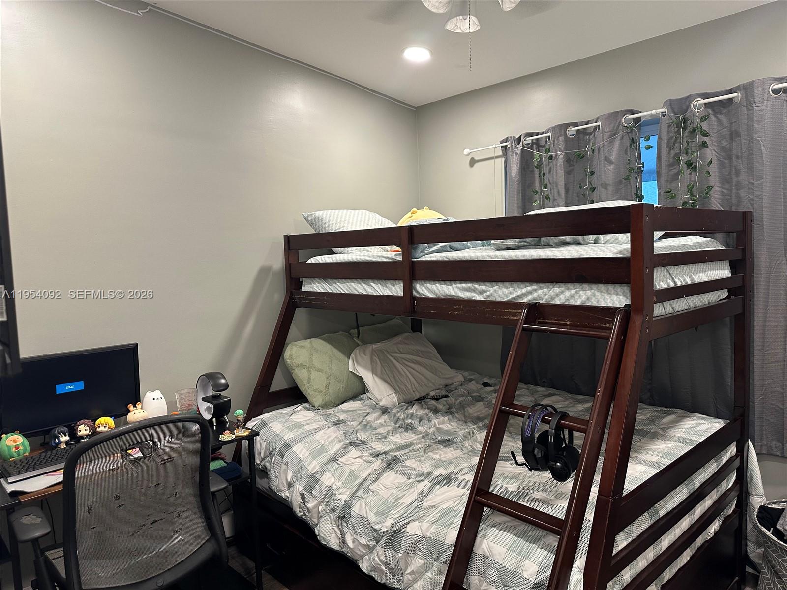 5700 Southwest 54th Terrace Davie, FL 33314 - Photo 29 of 49 a bedroom with a bed and a desk