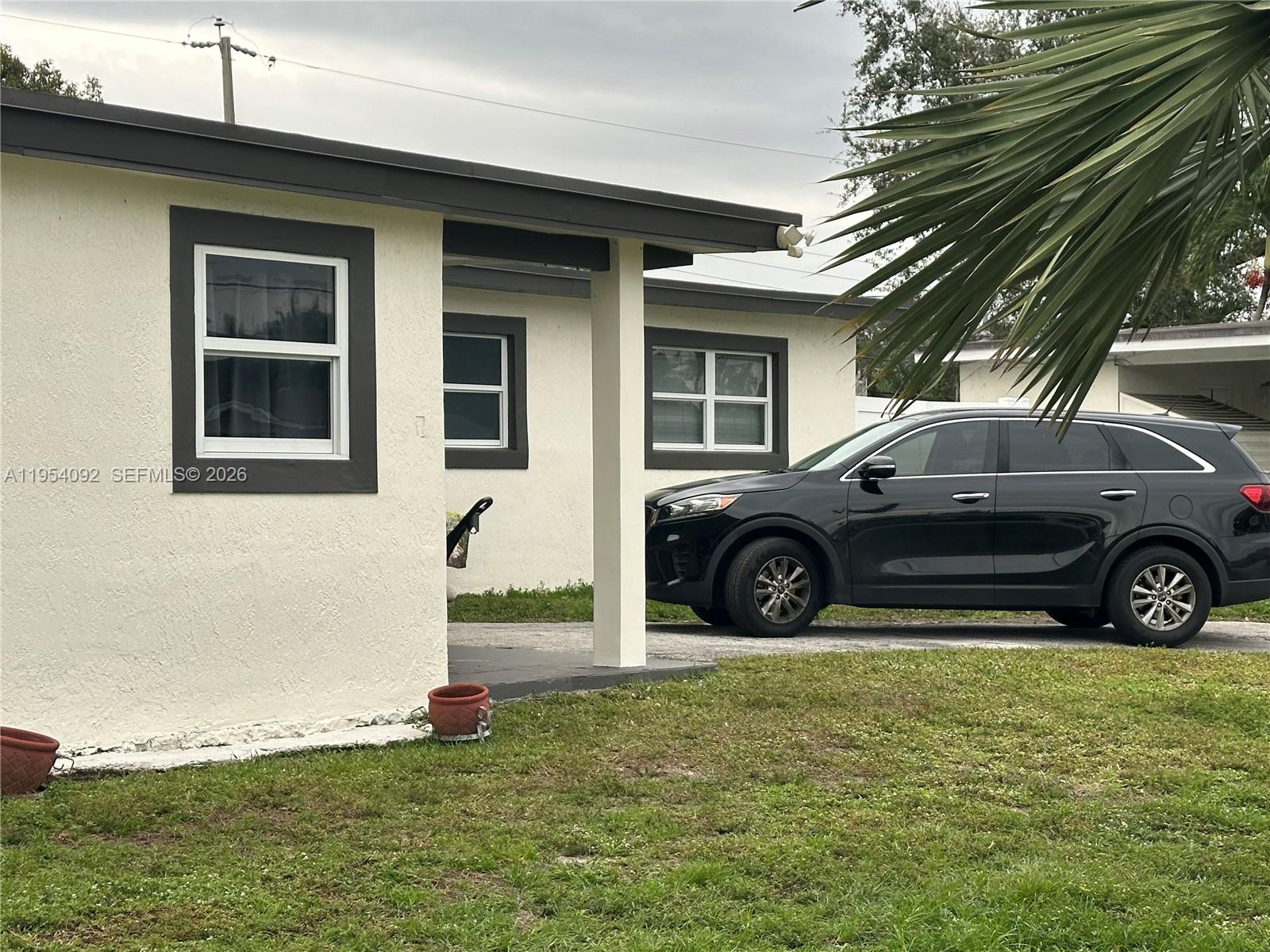 5700 Southwest 54th Terrace Davie, FL 33314 - Photo 3 of 49 a view of a car parked in front of a house