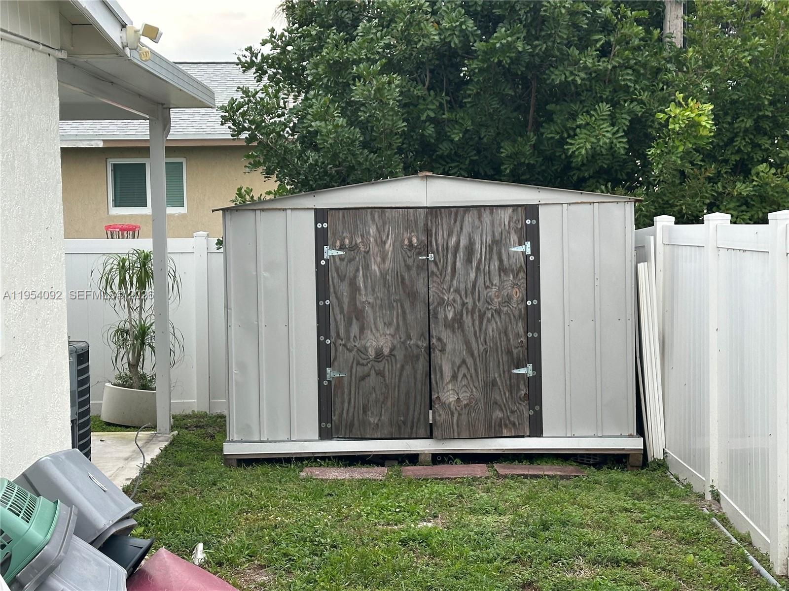 5700 Southwest 54th Terrace Davie, FL 33314 - Photo 35 of 49 a view of a house with a small yard and wooden fence