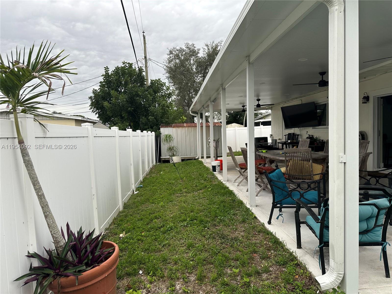 5700 Southwest 54th Terrace Davie, FL 33314 - Photo 40 of 49 a view of a backyard with potted plants and a large tree