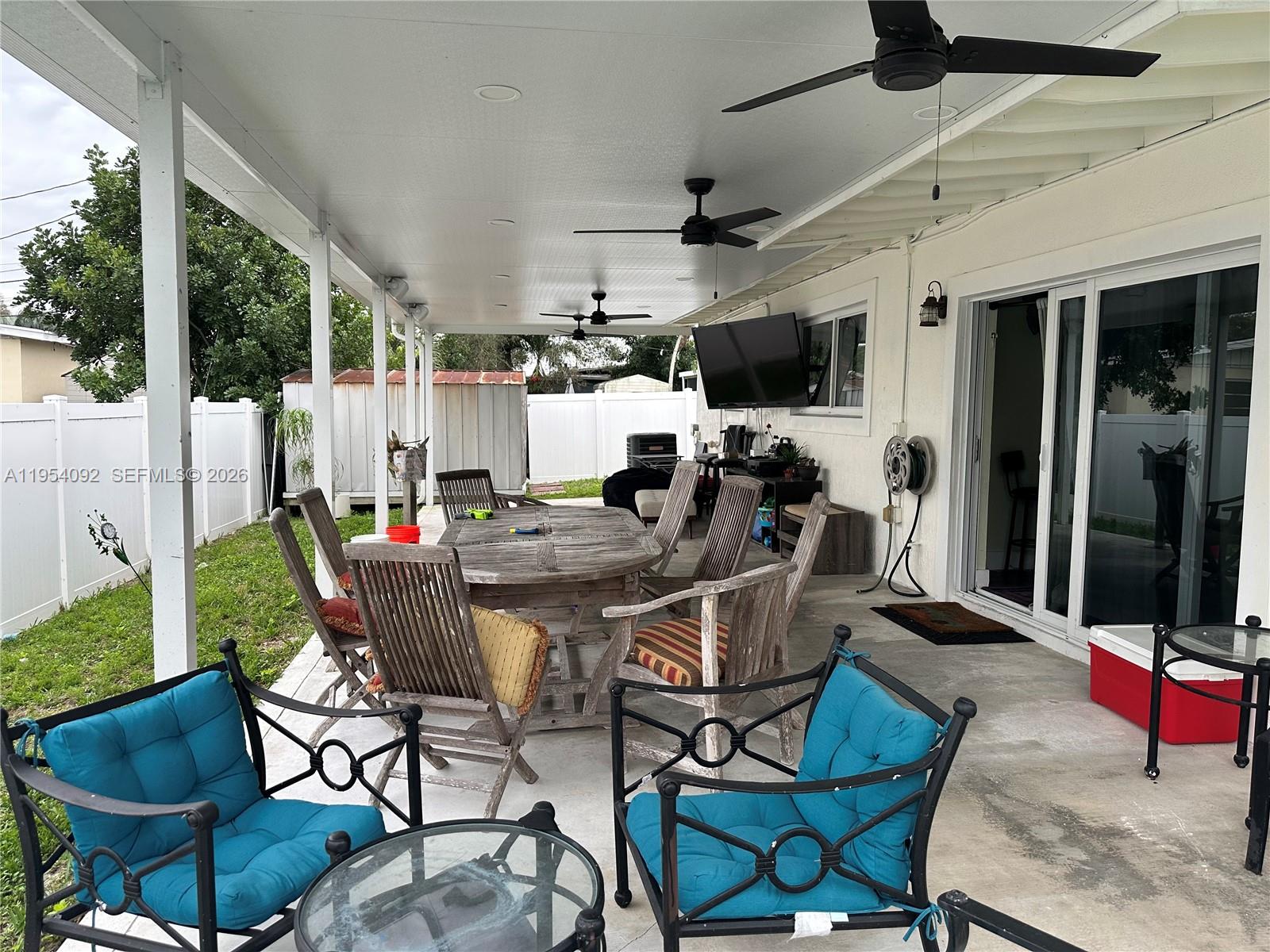 5700 Southwest 54th Terrace Davie, FL 33314 - Photo 41 of 49 a view of a dining room and tables and chairs in patio