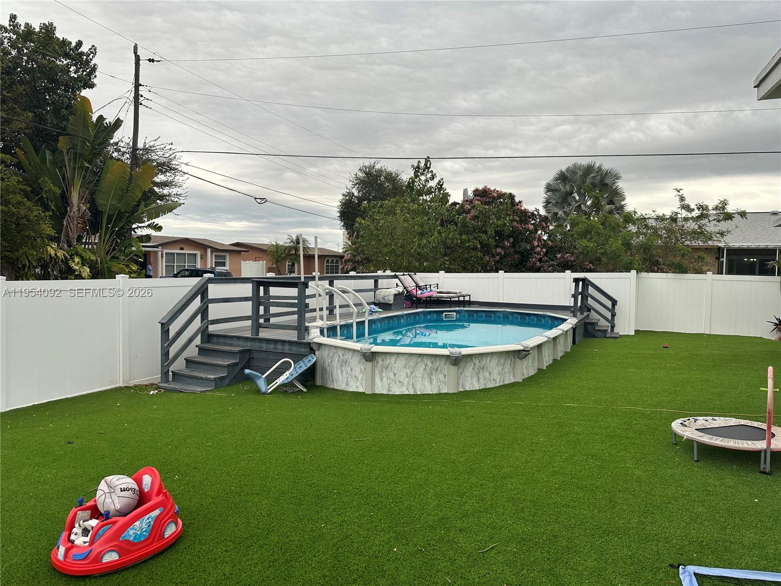 5700 Southwest 54th Terrace Davie, FL 33314 - Photo 42 of 49 a view of a swimming pool with a yard