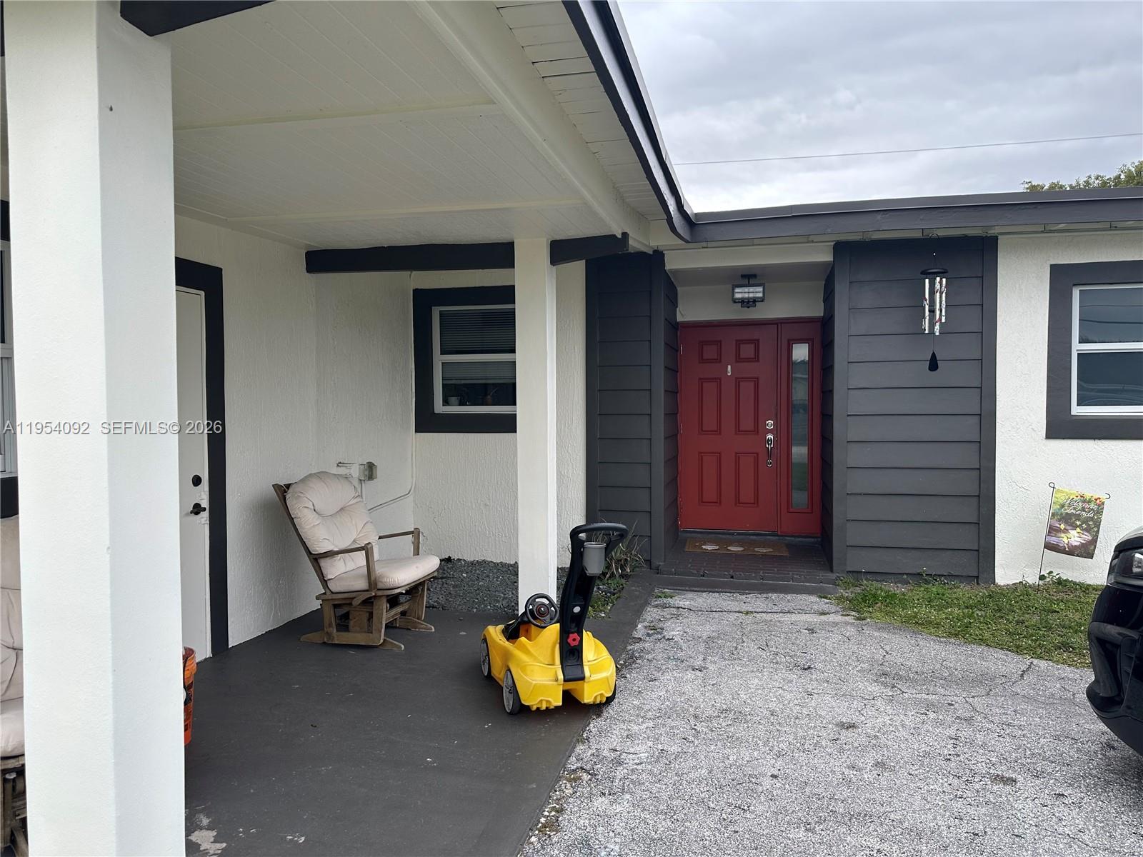 5700 Southwest 54th Terrace Davie, FL 33314 - Photo 6 of 49 a bench is sitting in front of a house