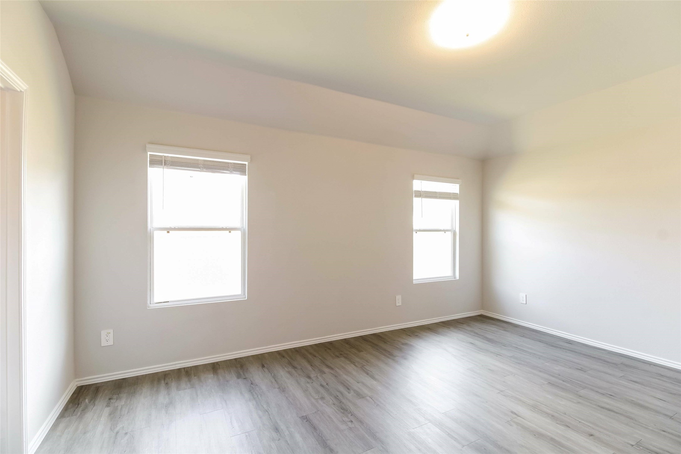 2528 Shad Drive Conroe, TX 77384 - Photo 5 of 16 an empty room with wooden floor and windows