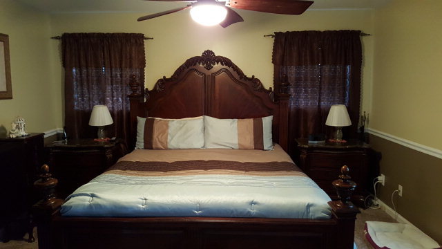 295 North Cross Road Gray, GA 31032 - Photo 15 of 26 a bedroom with a bed and a lamp