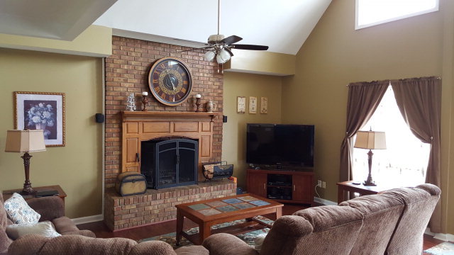295 North Cross Road Gray, GA 31032 - Photo 8 of 26 a living room with furniture a flat screen tv and a fireplace