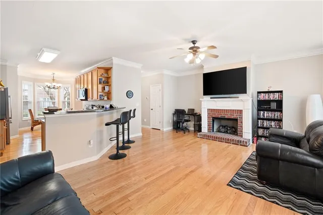 a living room with furniture a fireplace and a flat screen tv
