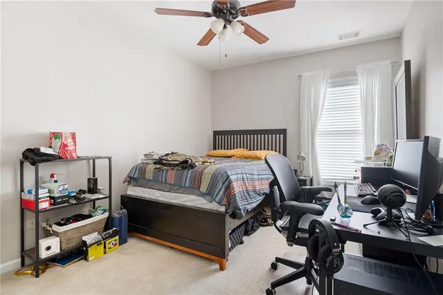 a bedroom with bed and a window