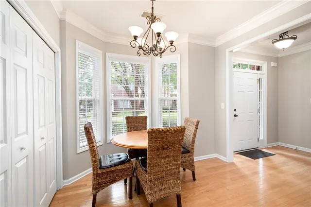 a view of a dining room with furniture wooden floor and chandelier