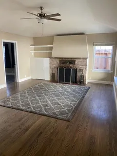 a kitchen with granite countertop a sink stove and refrigerator