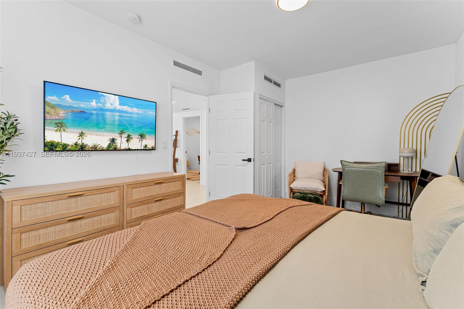 1144 Southwest 4th Street, Unit 8 Miami, FL 33130 - Photo 13 of 16 a bedroom with a bed and a flat screen tv