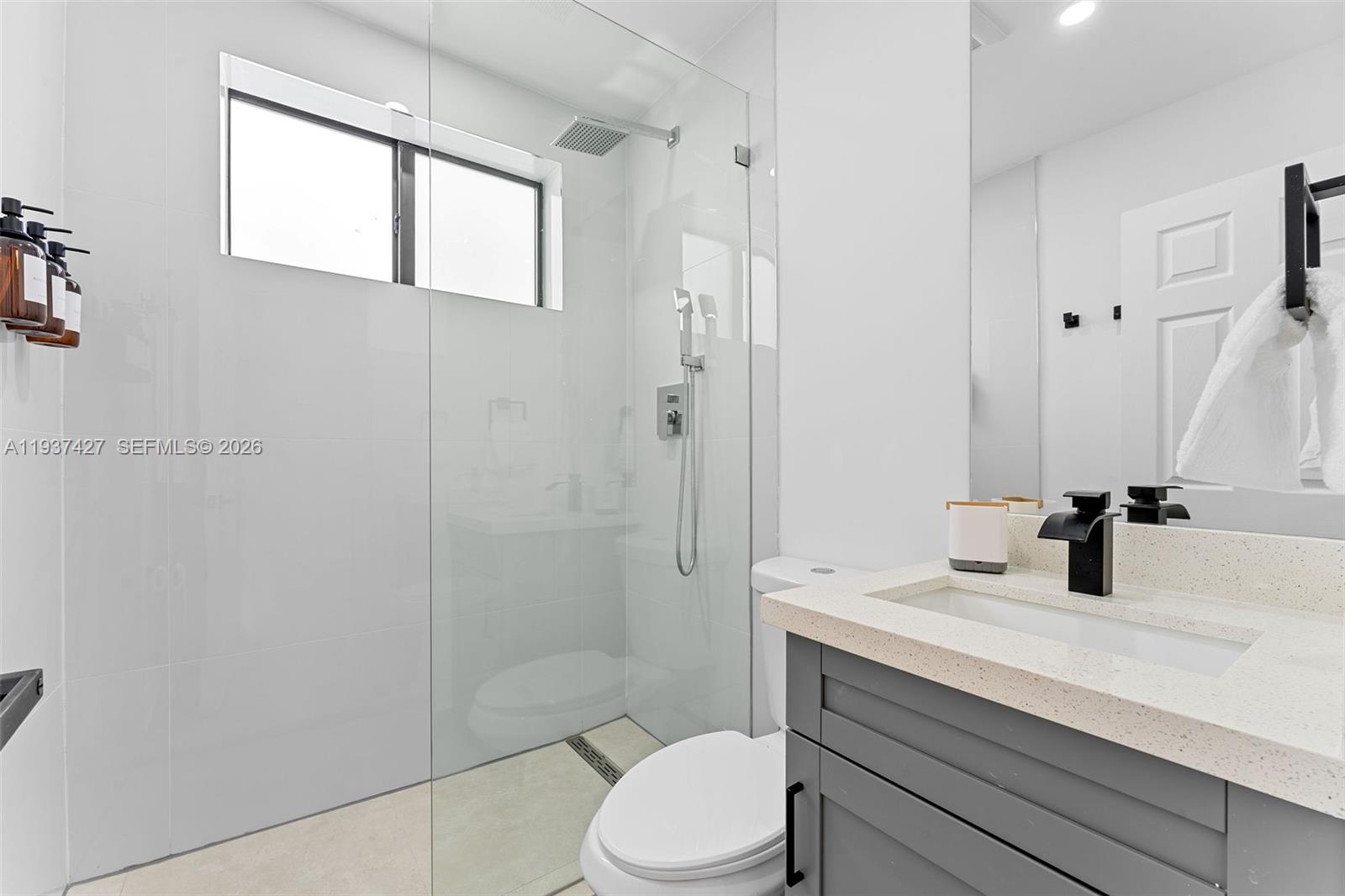 1144 Southwest 4th Street, Unit 8 Miami, FL 33130 - Photo 14 of 16 a bathroom with a sink toilet and shower