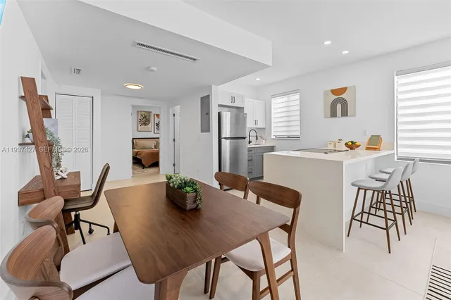a dining room with furniture and window