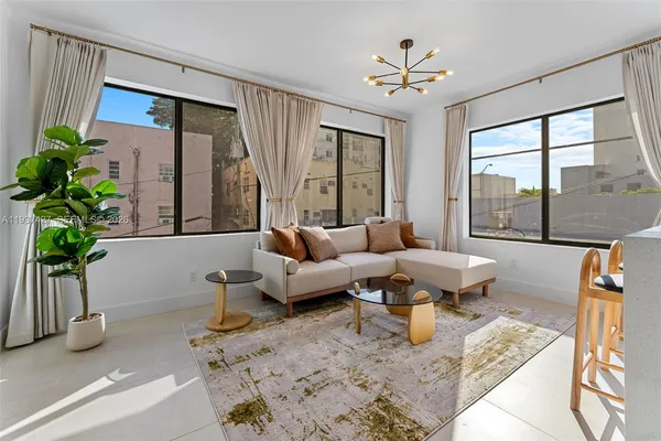 a living room with furniture and a large window