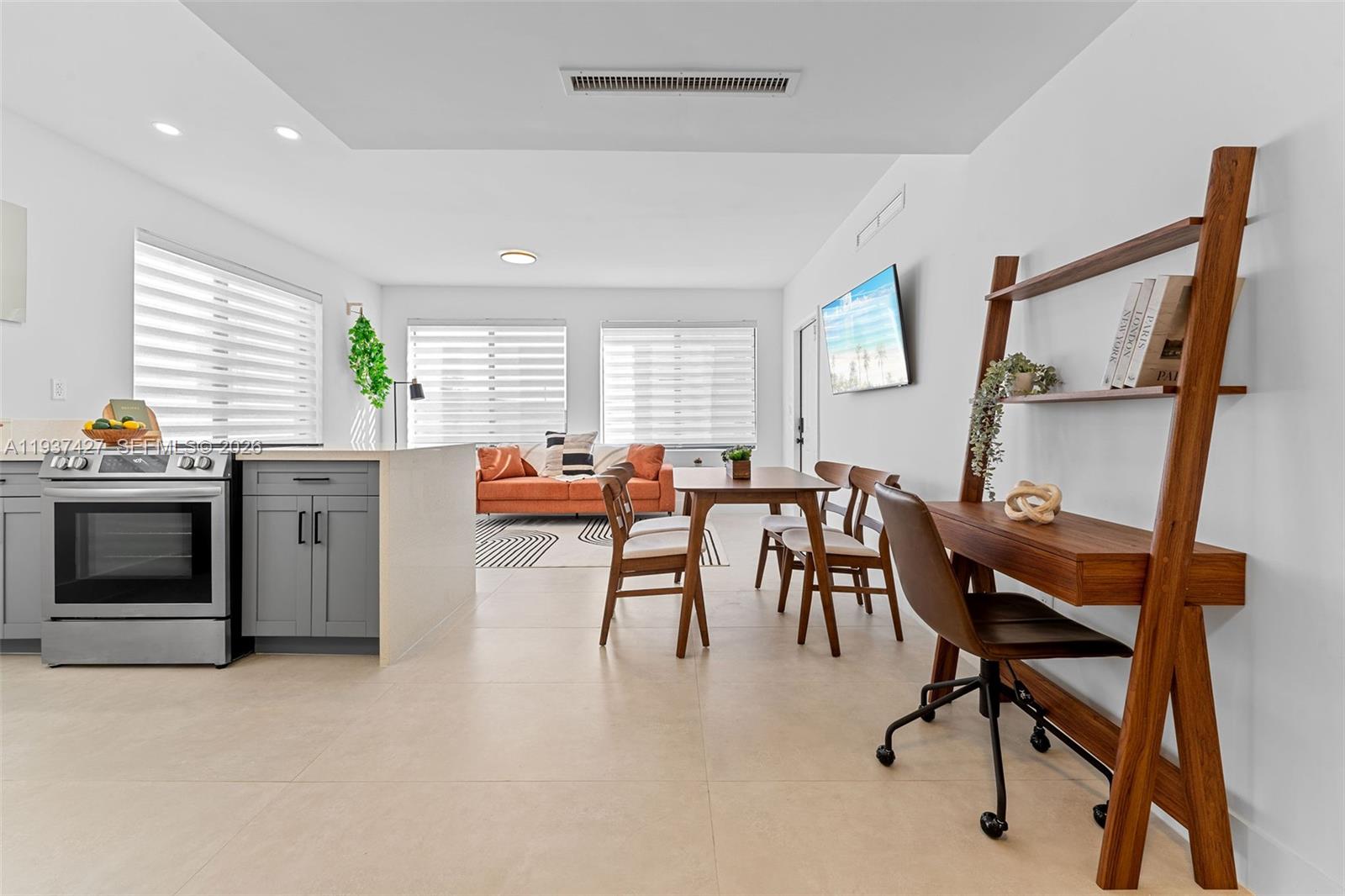 1144 Southwest 4th Street, Unit 8 Miami, FL 33130 - Photo 7 of 16 a room with stainless steel appliances dining table chairs and a window
