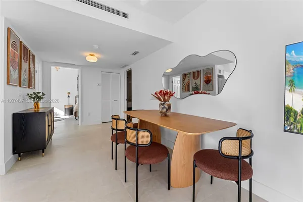 a view of a dining room with furniture and a chandelier