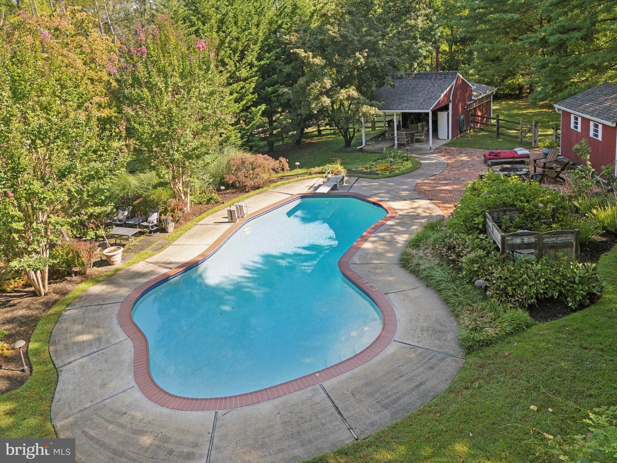 4104 Tinker Hill Road Phoenixville, PA 19460 - Photo 18 of 63 a view of a swimming pool with a yard and sitting space