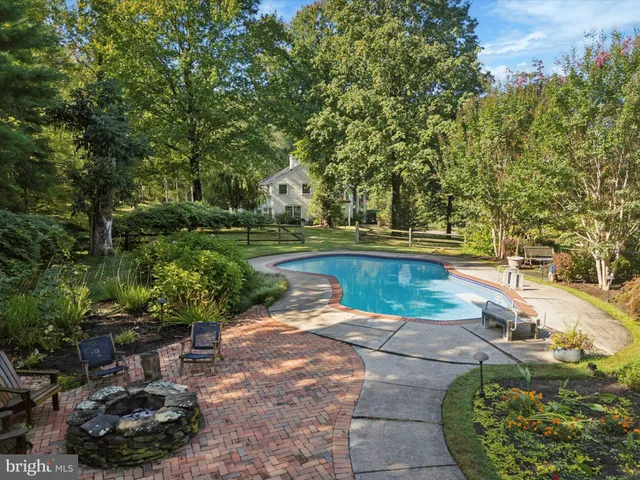 an aerial view of a house with a yard and large trees