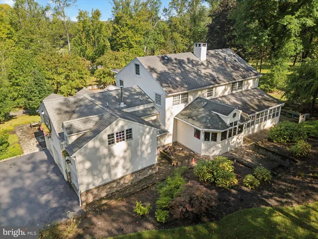 a dining room with furniture wooden floor a rug and a chandelier