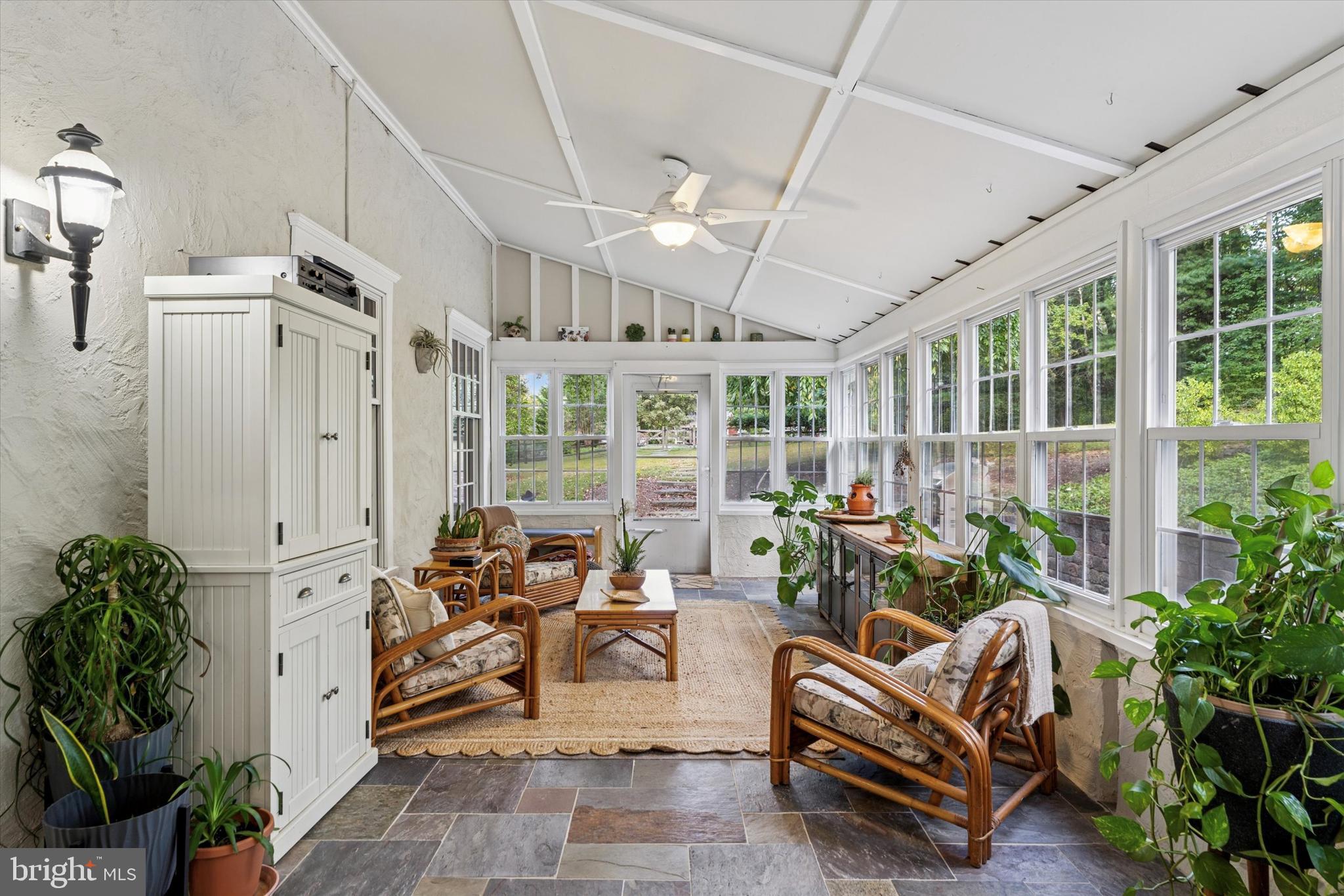 4104 Tinker Hill Road Phoenixville, PA 19460 - Photo 34 of 63 a living room with patio furniture and potted plants