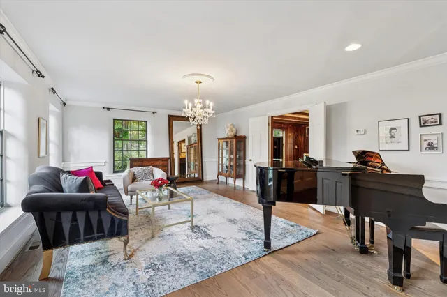 a view of a livingroom with furniture a flat screen tv and a large window