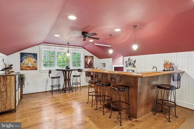 a bedroom with bed and wooden floor
