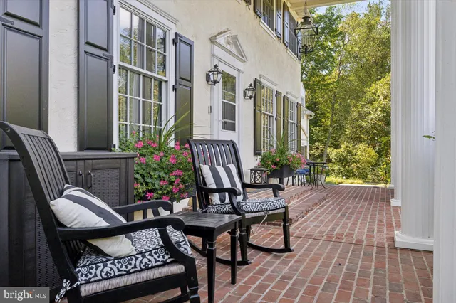 a view of a patio with table and chairs and potted plants