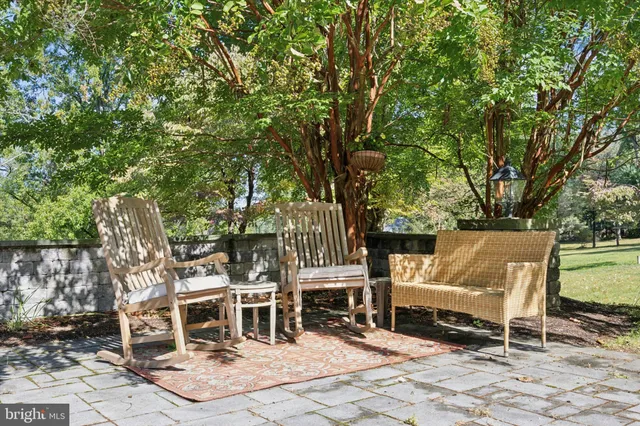 a view of a chairs and table in the back yard of the house