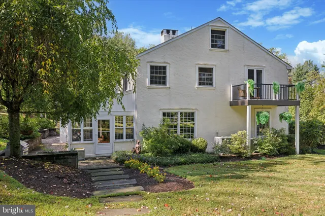 a view of a house with a yard and sitting area