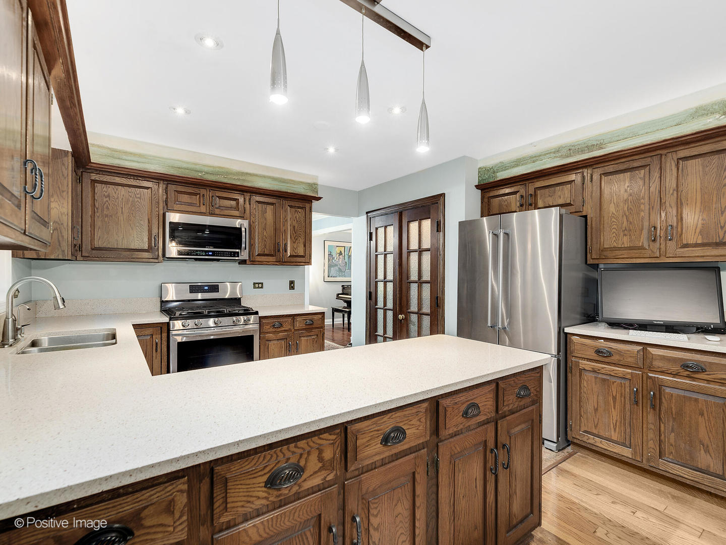 N412 Indian Knoll Road West Chicago, IL 60185 - Photo 11 of 25 a kitchen with stainless steel appliances a stove sink microwave and cabinets