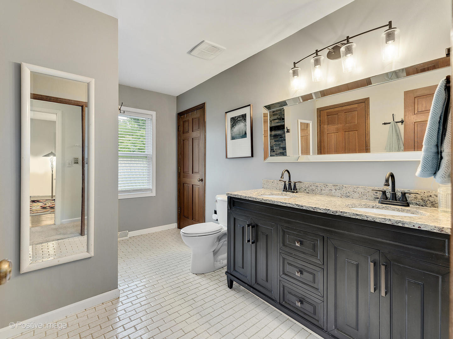 N412 Indian Knoll Road West Chicago, IL 60185 - Photo 18 of 25 a spacious bathroom with a granite countertop sink and a mirror