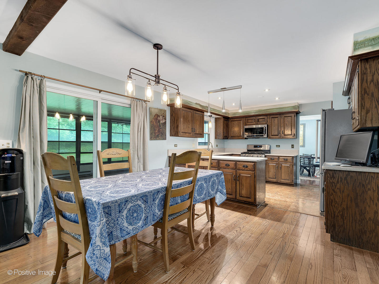 N412 Indian Knoll Road West Chicago, IL 60185 - Photo 8 of 25 a kitchen with stainless steel appliances granite countertop a stove top oven a refrigerator a kitchen island a dining table and chairs with wooden floor