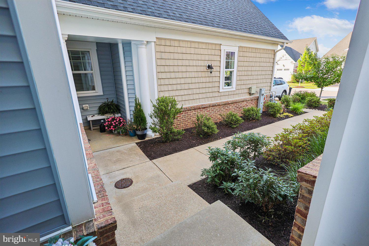 3068 Spring Peeper Court Odenton, MD 21113 - Photo 7 of 29 a potted plant sitting in front of a house