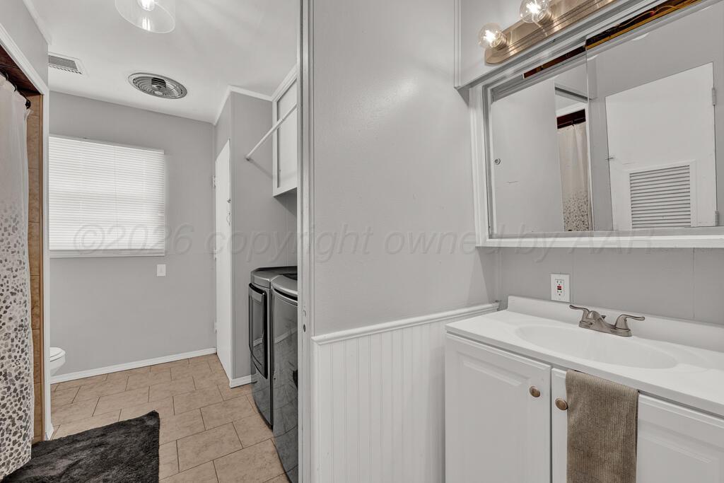 5016 Leigh Avenue Amarillo, TX 79110 - Photo 15 of 21 a bathroom with a sink and a mirror