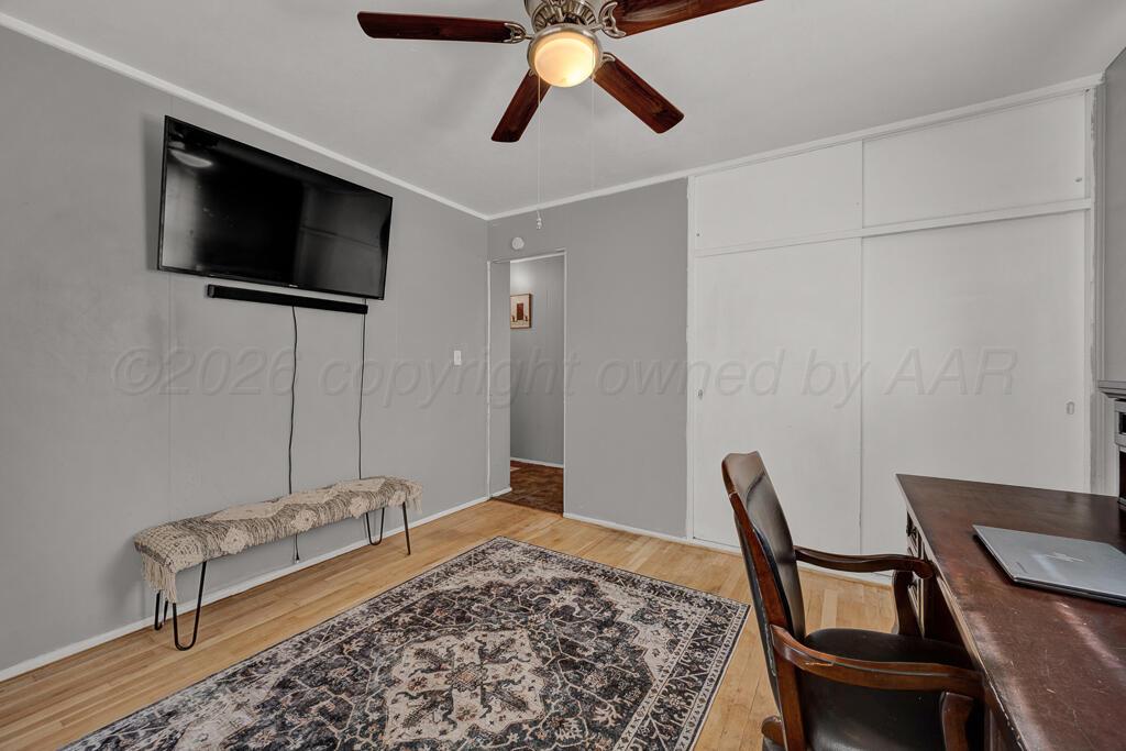 5016 Leigh Avenue Amarillo, TX 79110 - Photo 18 of 21 a view of a workspace with furniture and a flat screen tv