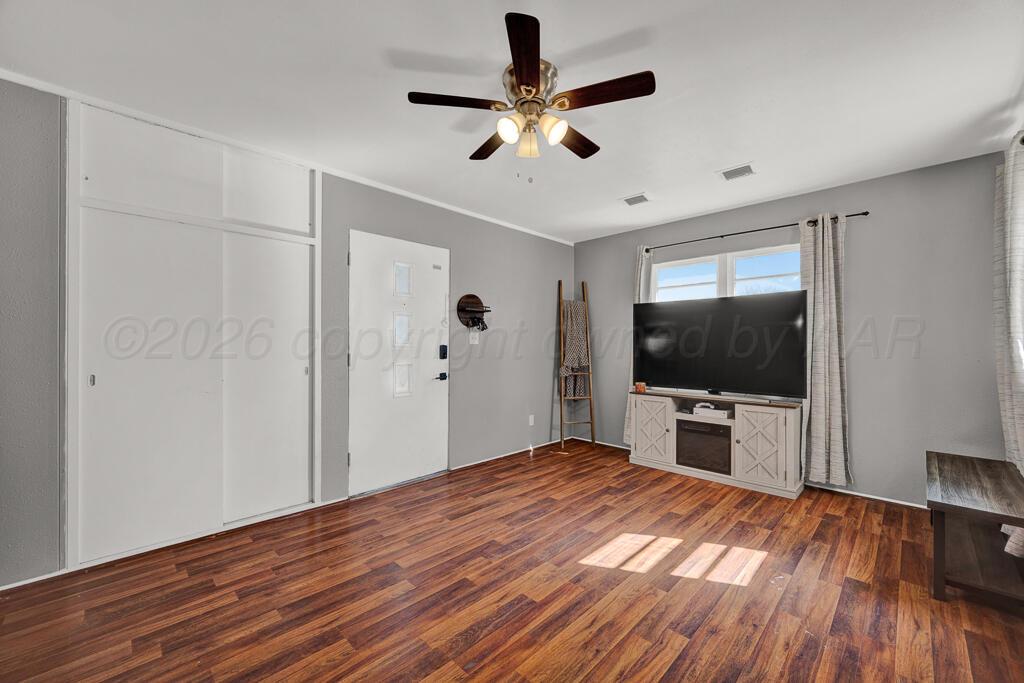 5016 Leigh Avenue Amarillo, TX 79110 - Photo 6 of 21 a bedroom with a bed and a flat screen tv