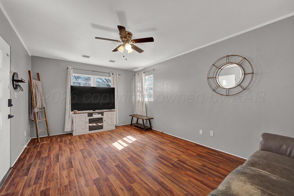 5016 Leigh Avenue Amarillo, TX 79110 - Photo 7 of 21 a view of a livingroom with wooden floor and a flat screen tv