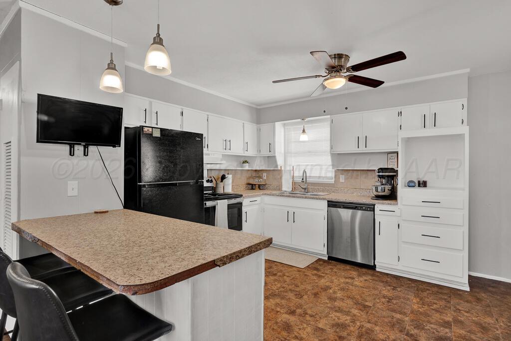 5016 Leigh Avenue Amarillo, TX 79110 - Photo 8 of 21 a kitchen with cabinets appliances and a counter space
