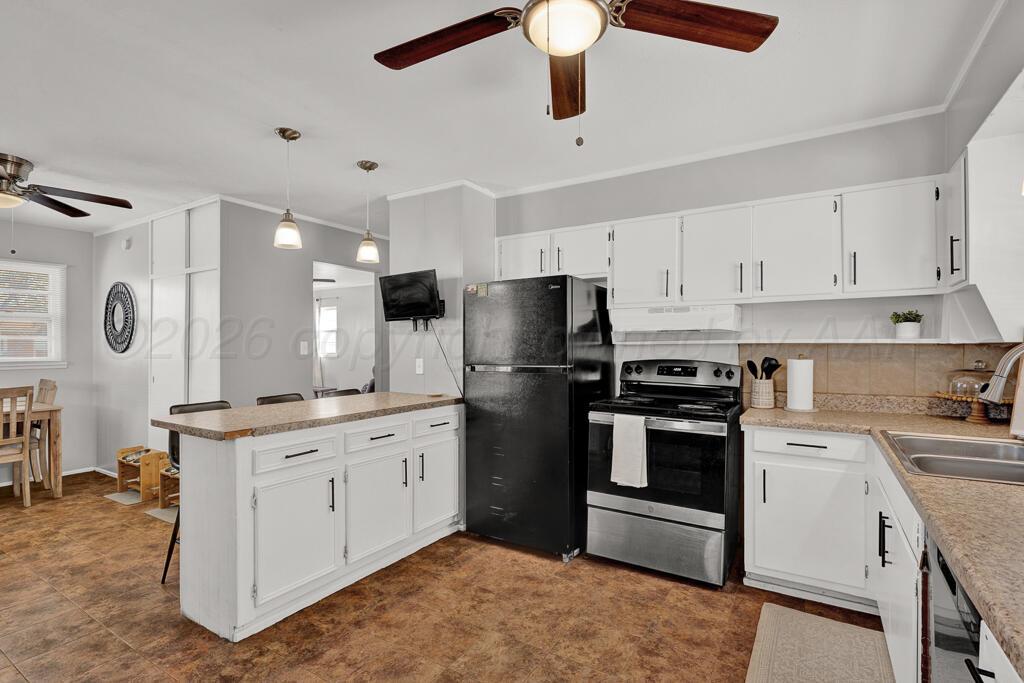 5016 Leigh Avenue Amarillo, TX 79110 - Photo 9 of 21 a kitchen with a stove sink and refrigerator