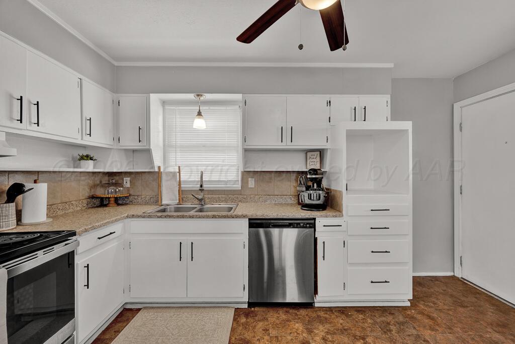 5016 Leigh Avenue Amarillo, TX 79110 - Photo 10 of 21 a kitchen with granite countertop white cabinets and white appliances