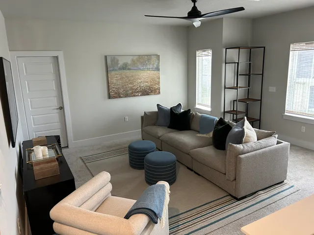 a living room with furniture and a large window