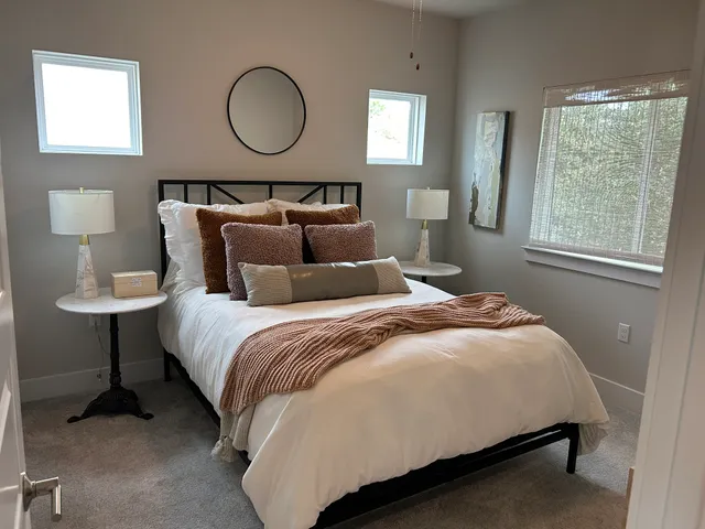 a bedroom with a bed and a lamp