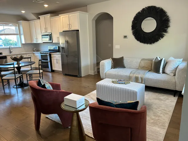 a living room with furniture and kitchen view