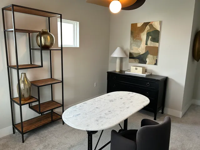 a view of a livingroom with furniture and a mirror